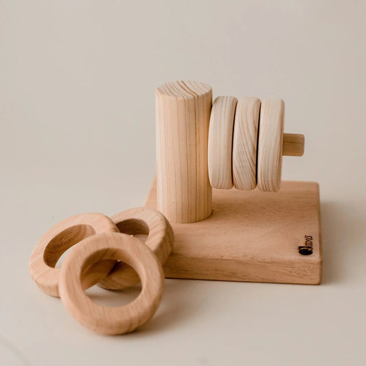 Wooden toy with rings on a plain background