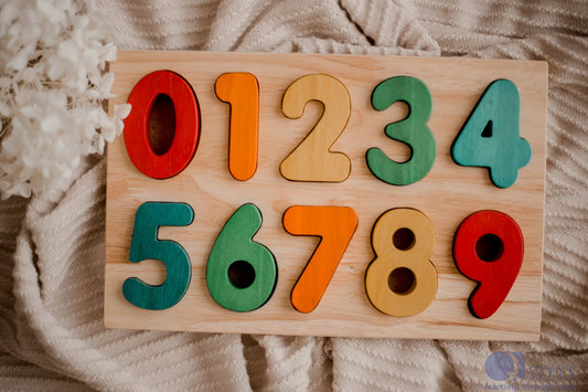 Wooden number puzzle with colorful numbers on a textured fabric background