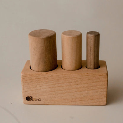 Wooden toy with cylindrical blocks on a plain background