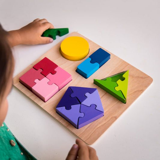Child playing with Kiddie Connect brand jigsaw fractions wooden puzzle