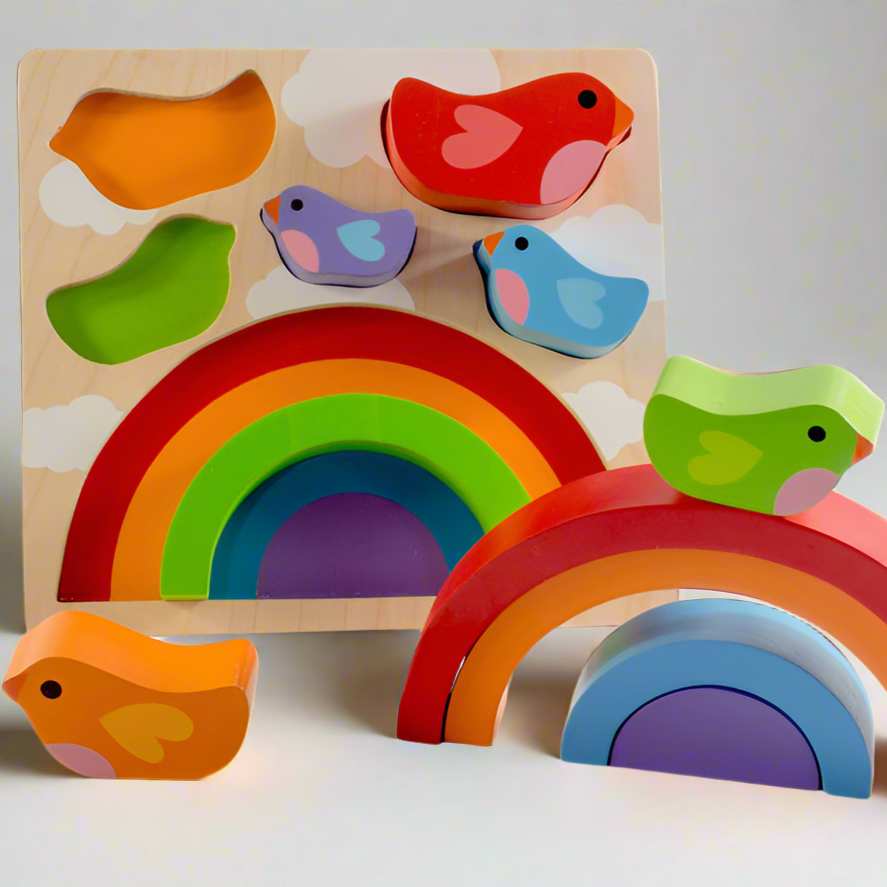 Colorful wooden toy set with birds and rainbows on a light background