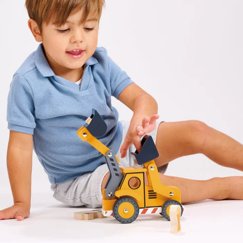 Child playing with a toy excavator on a white background