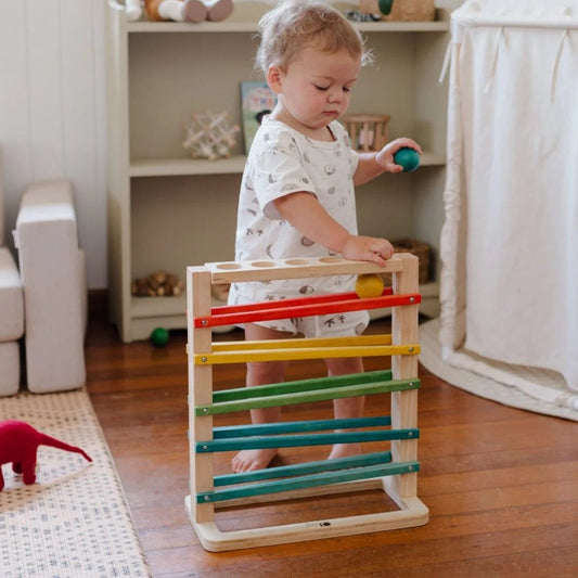 Child enjoying playing with the QToys track a ball rack from Curious Moonbeam